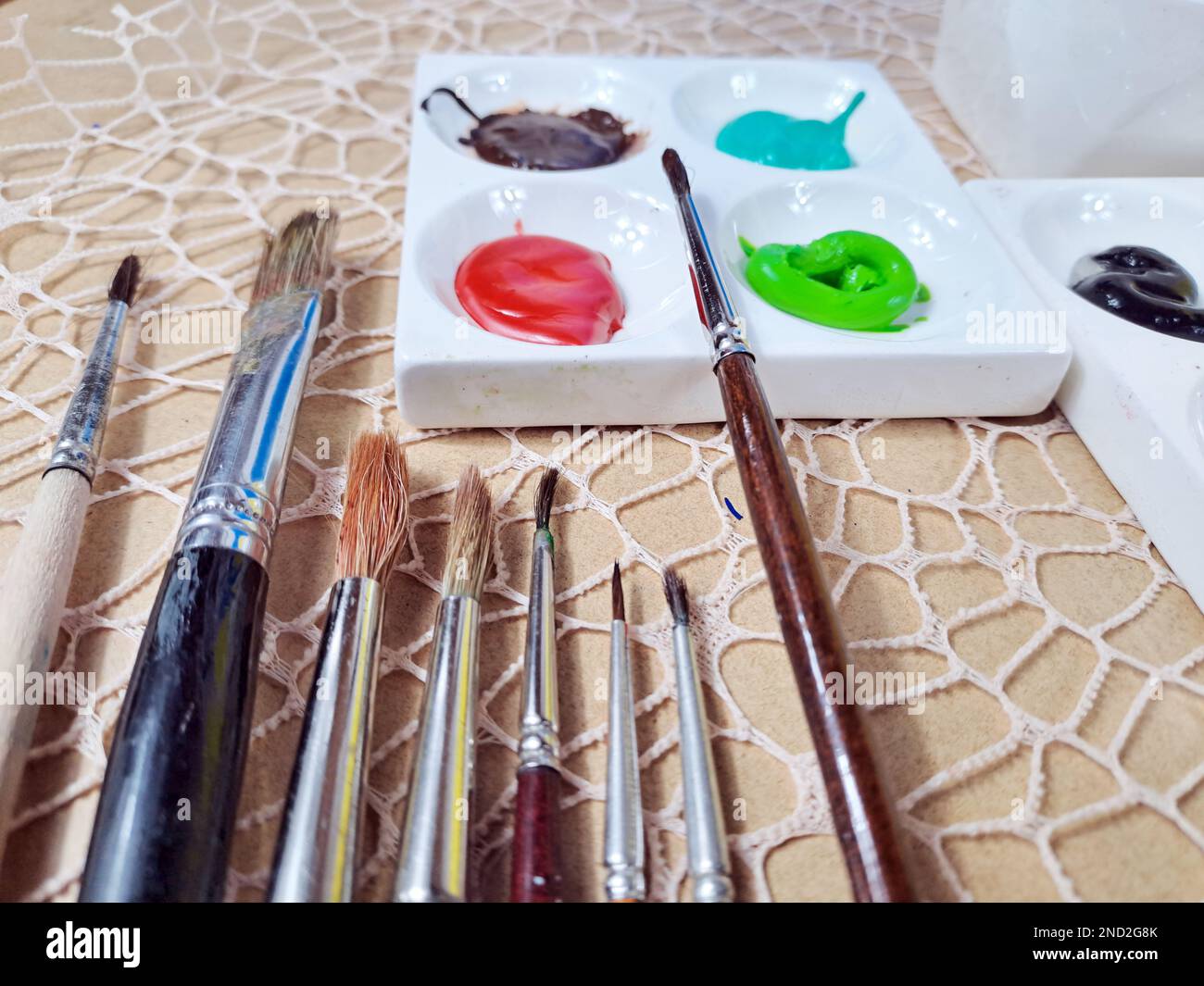 Arbeitsplatz Der Aktivität „Künstlerzeichnung“, „Skizzenblock“, „Zeichenkunst Produkt Interpret“, „Skizze“. Nahaufnahme von Acrylfarbe mit Bürsten Stockfoto
