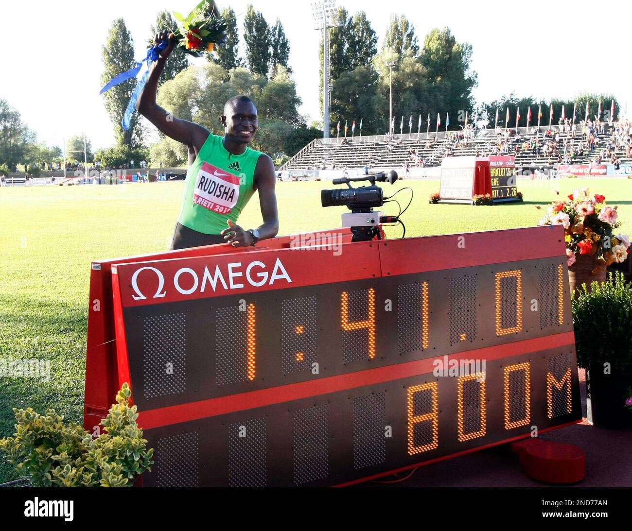 Kenya's David Rudisha poses behind the scoreboard after setting a world ...