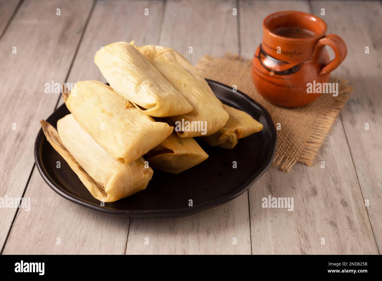 Tamales. Prähispanische Gericht typisch für Mexiko und einige lateinamerikanische Länder. Maisteig in Maisblätter gewickelt. Die Tamales werden gedämpft. Stockfoto