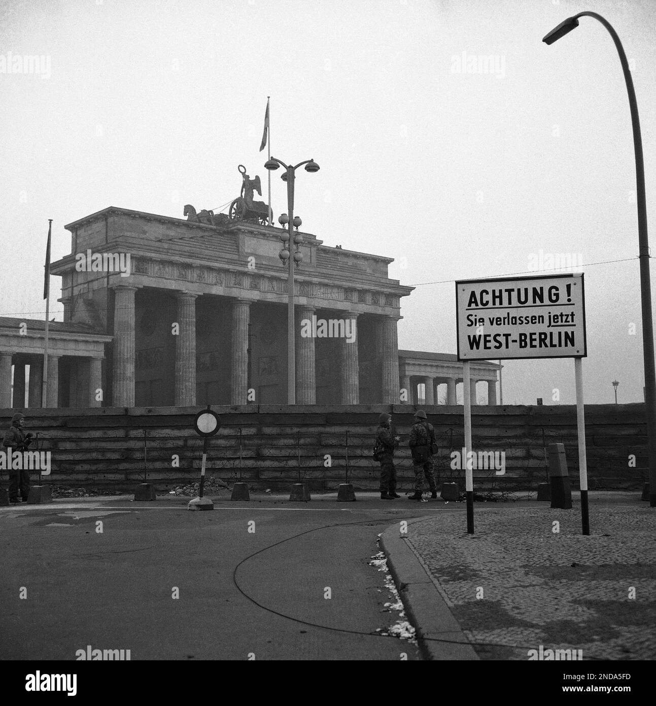 Three members of the East Berlin Vopos (people’s police) stand guard in