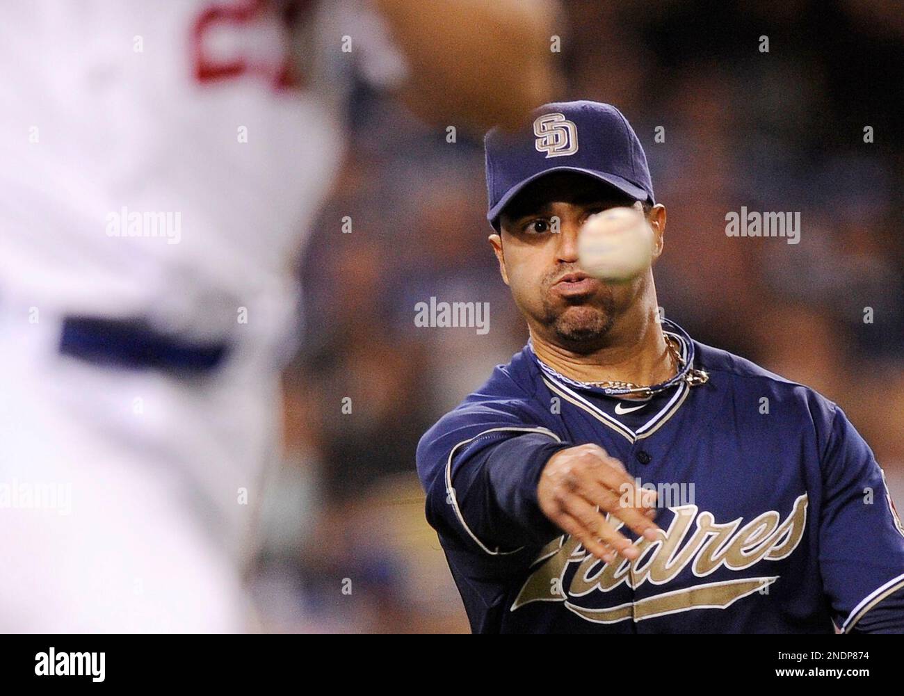 San Diego Padres shortstop Jerry Hairston Jr. throws out Los Angeles Dodgers' Clayton Kershaw left, at first during the fifth inning of their Major League baseball game, Thursday, May 20, 2010, in Los Angeles. (AP Photo/Mark J. Terrill) Stockfoto