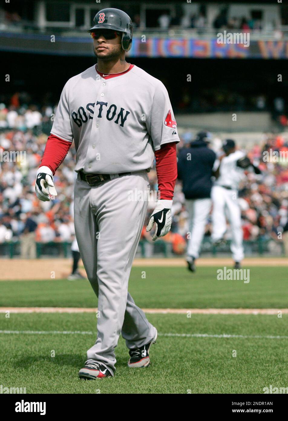 Boston Red Sox's Darnell McDonald walks off the field as the Detroit Tigers celebrate a 5-1 win in a baseball game Sunday, May 16, 2010, in Detroit. (AP Photo/Duane Burleson) Stockfoto
