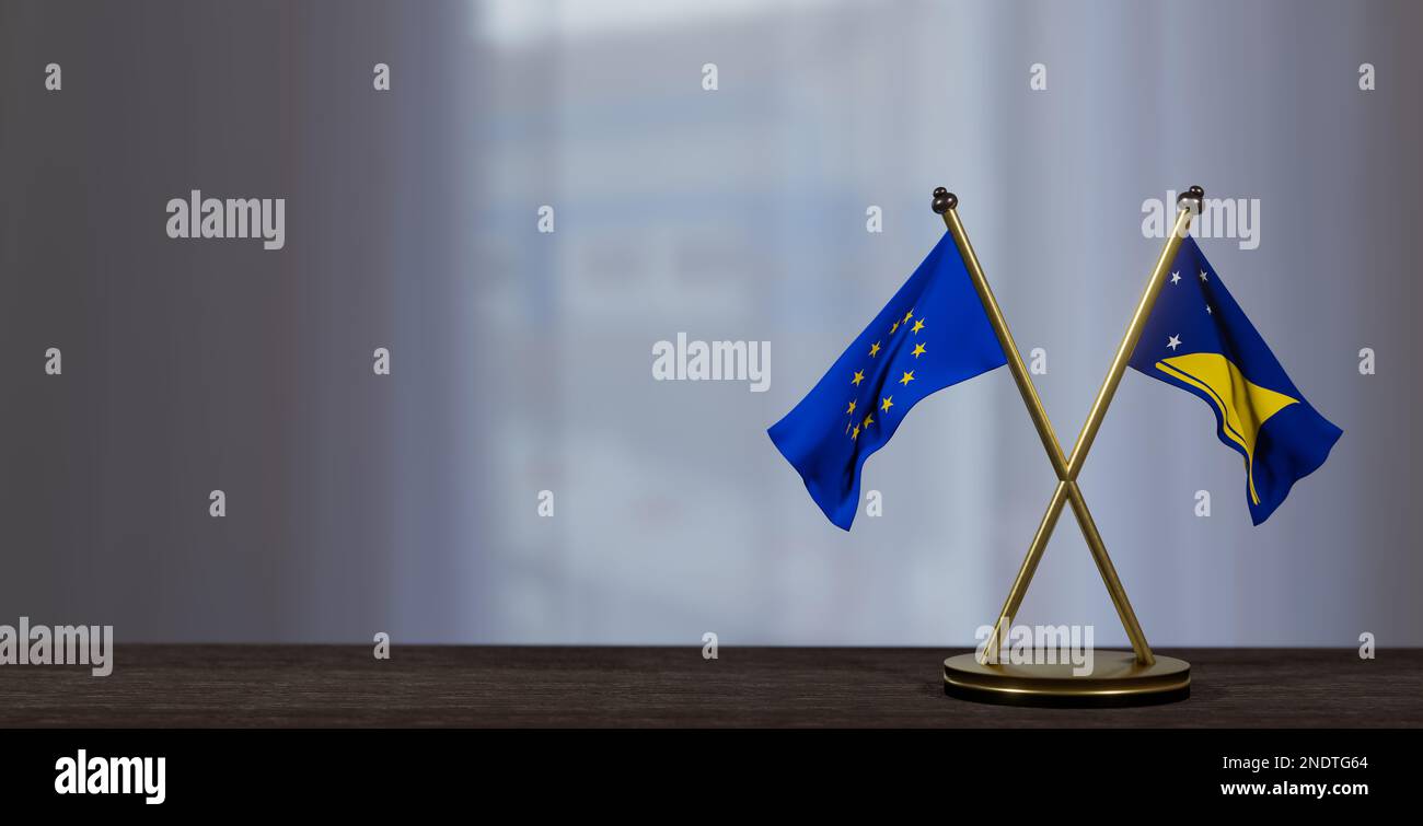 Tokelau- und Europaflaggen auf dem Tisch. Verhandlungen zwischen Tokelau und der EU. Auf wenig unscharfem Hintergrund. 3D Arbeit und 3D Bild Stockfoto