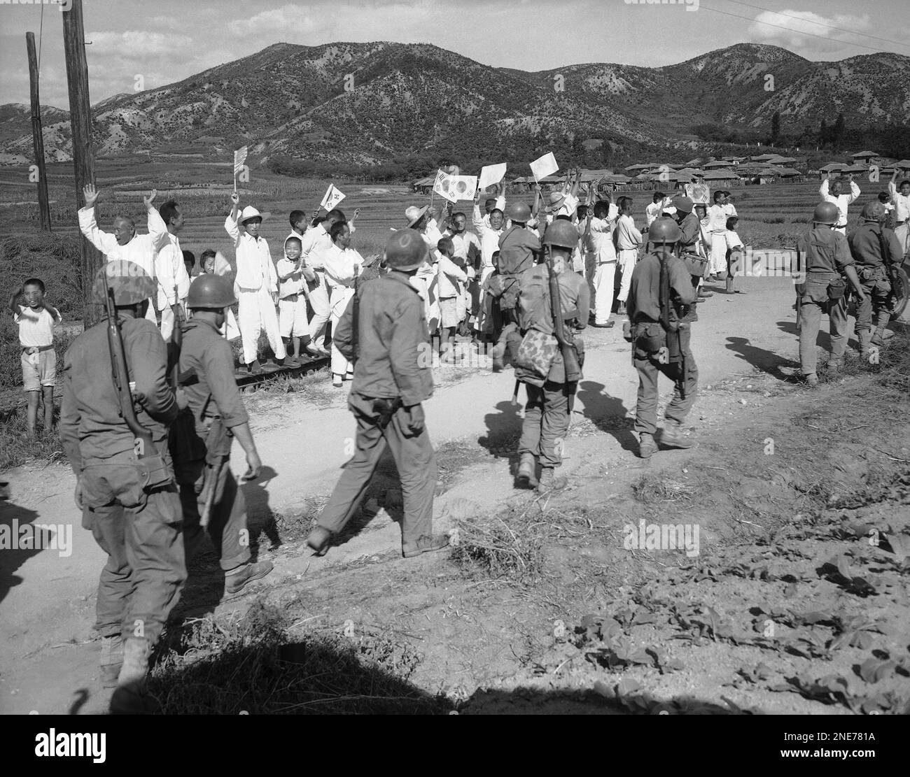 Natives wave Korean flags and yell greetings to U.S. Marines as the ...