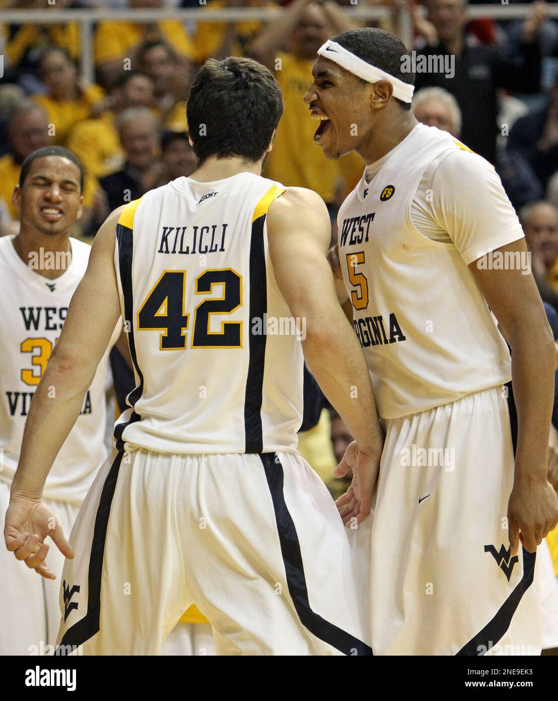 West Virginia's Deniz Kilicli (42), Wellington Smith, left, and Kevin
