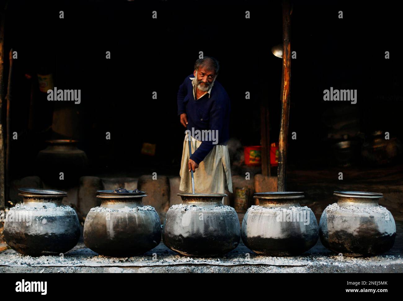 Imam Rice A Pakistani man cooks rice for visitors of the Beri Iman, a shrine of ...