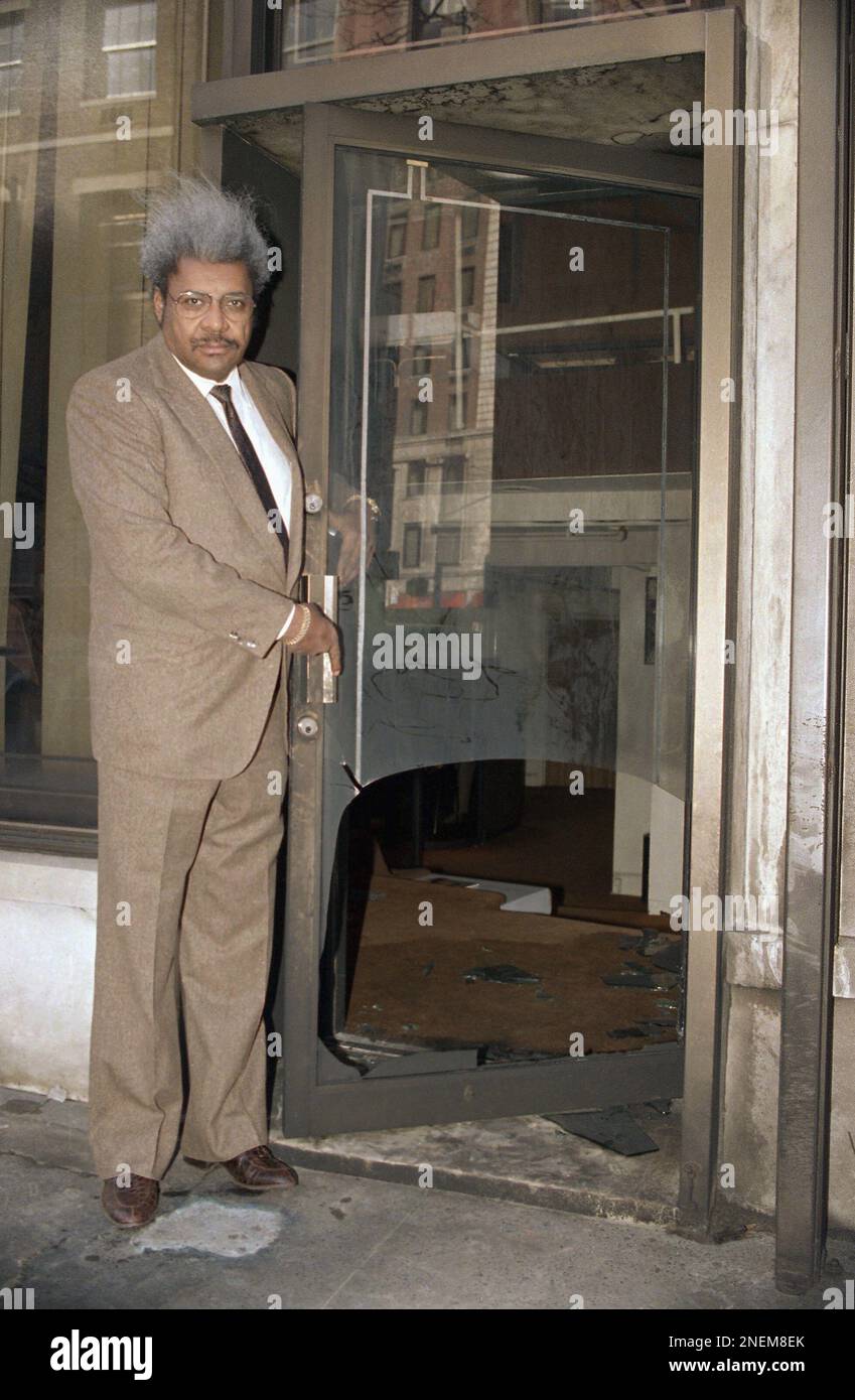 Fight promoter Don King stands by fire bombed glass door of his office