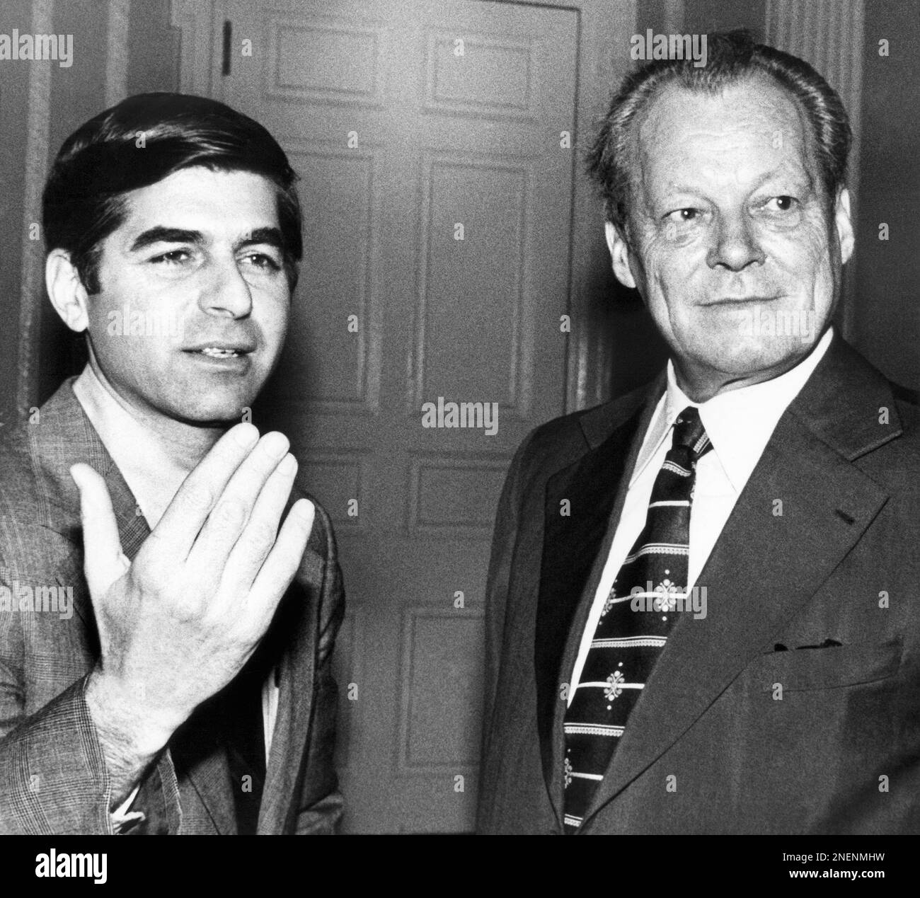 Former Chancellor of West Germany Willy Brandt, listens as Gov. Michael