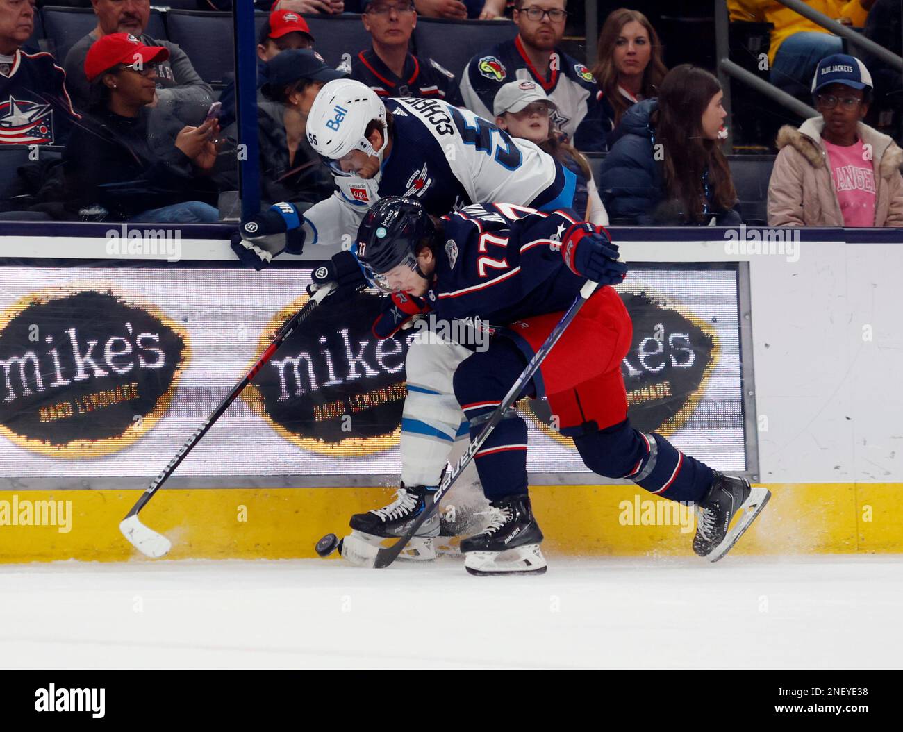 Columbus Blue Jackets defenseman Nick Blankenburg, front, checks Winnipeg Jets forward Mark Scheifele during the first period of an NHL hockey game in Columbus, Ohio, Thursday, Feb. 16, 2023. (AP Photo/Paul Vernon) Stockfoto