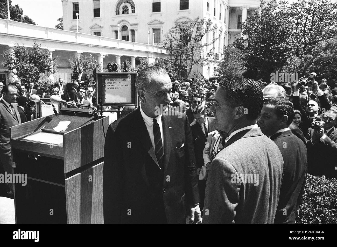 President Lyndon Johnson chats with Sargent Shriver, director of the