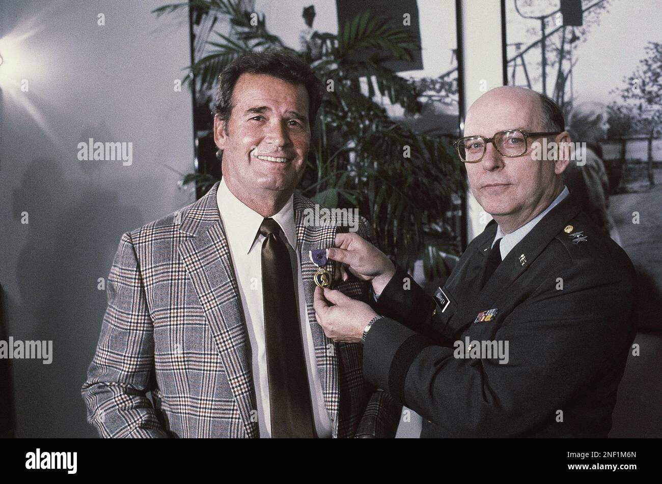 Actor James Garner, left, is all smiles as he holds up the Purple Heart