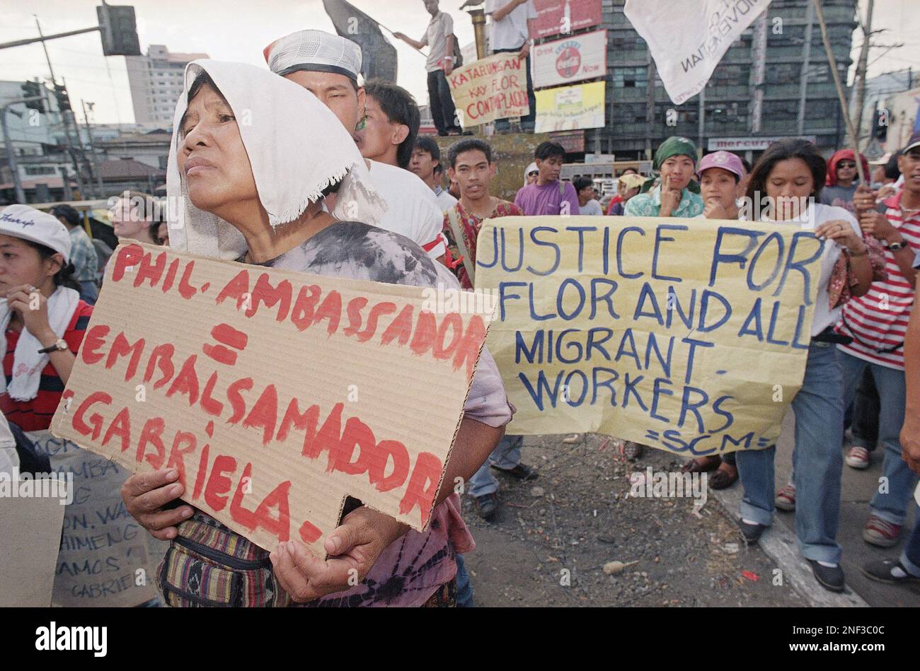 Demonstrators display protest placards during a rally near the ...