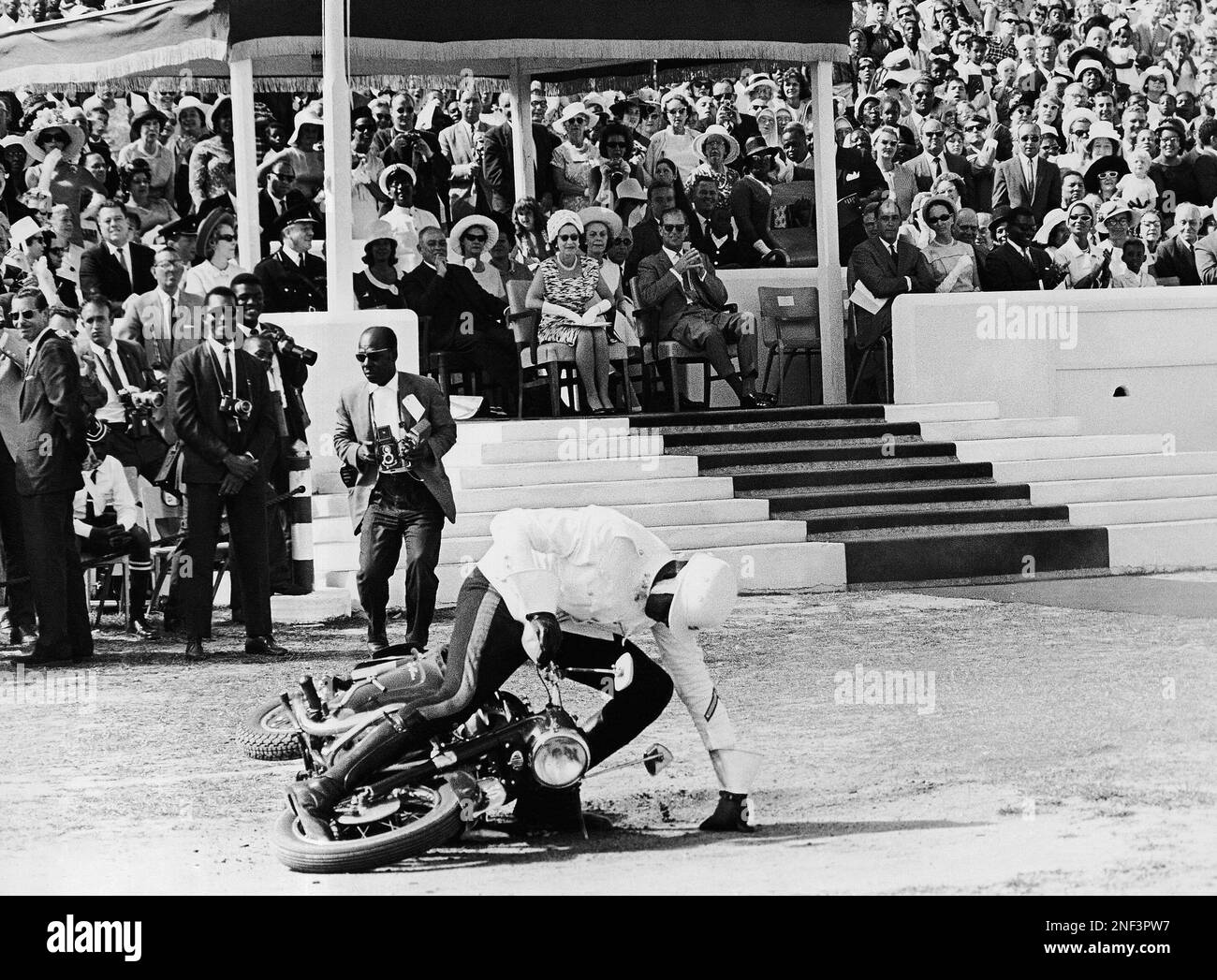 Nassau police rider, Lockhart, takes a fall in front of Queen