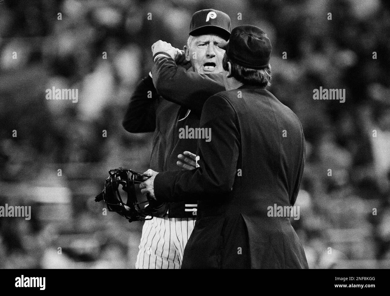 Phillies manager Paul Owens, left, is not getting ready to hit umpire