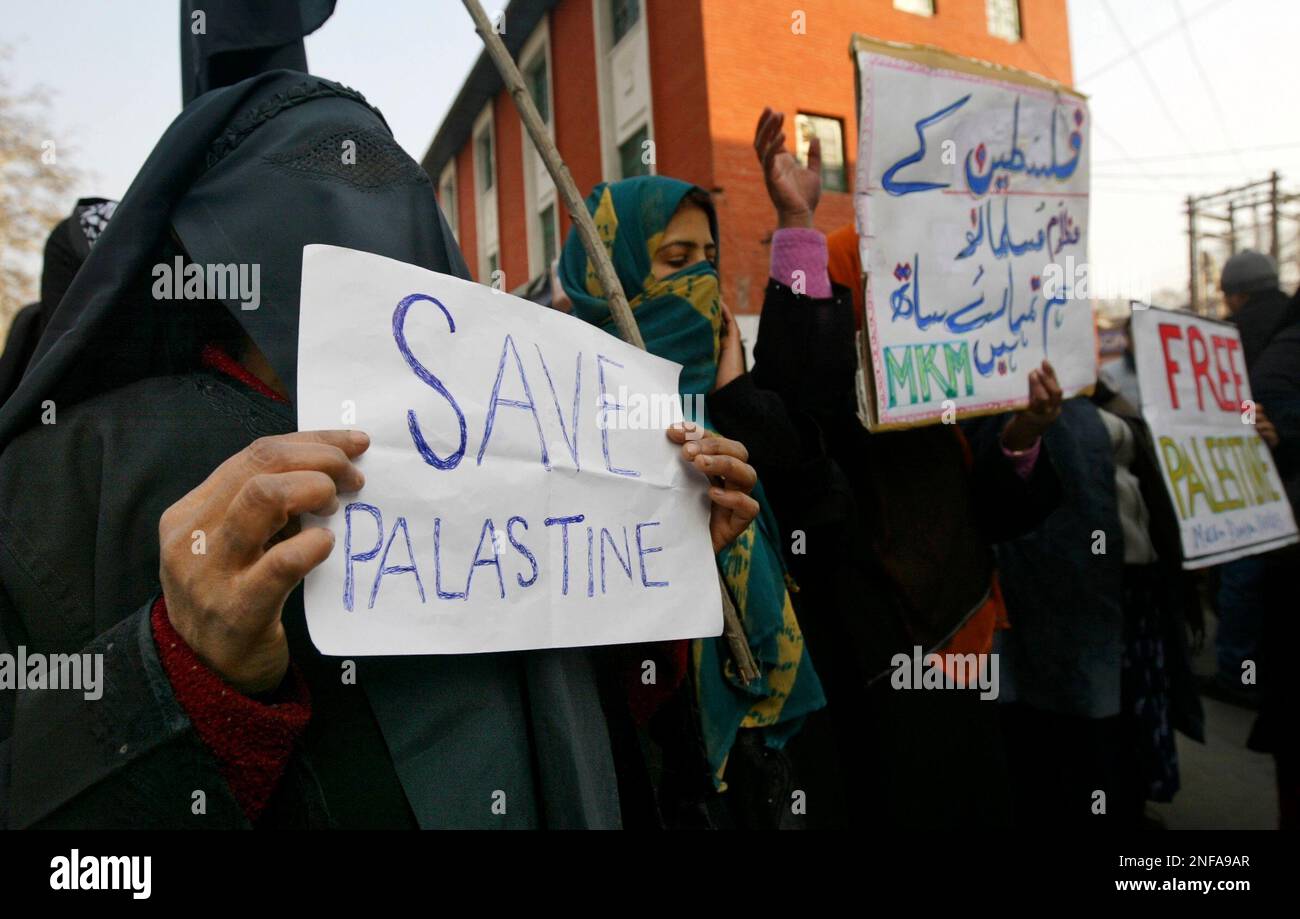 Veiled activists of Jammu Kashmir’s Muslim Khawateen Markaz, or Muslim women center, shout anti-Israel government slogans during a protest against the Israeli assault on Gaza, in Srinagar, India, Wednesday, Dec. 31, 2008. The placard in Urdu reads, “Oppressed Muslims of Palestine we are with you.”(AP Photo/Dar Yasin) Stockfoto