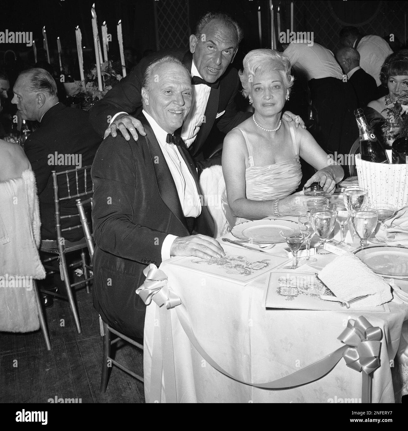 Playwright Moss Hart stands over theatrical director Joshua Logan and