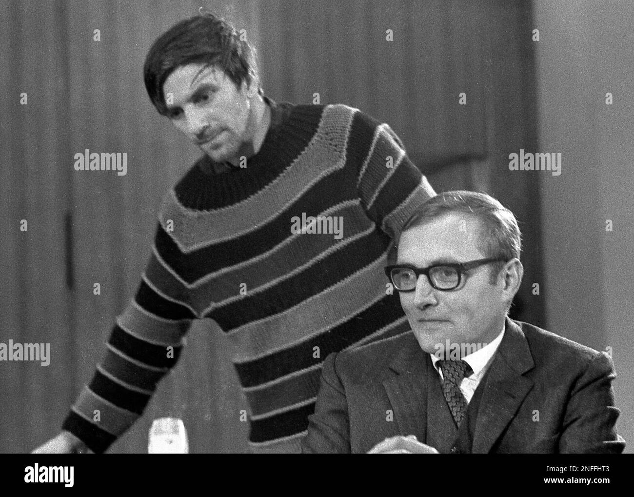 Rudi Dutschke takes a seat next to Rudolf Augstein, right, publisher of