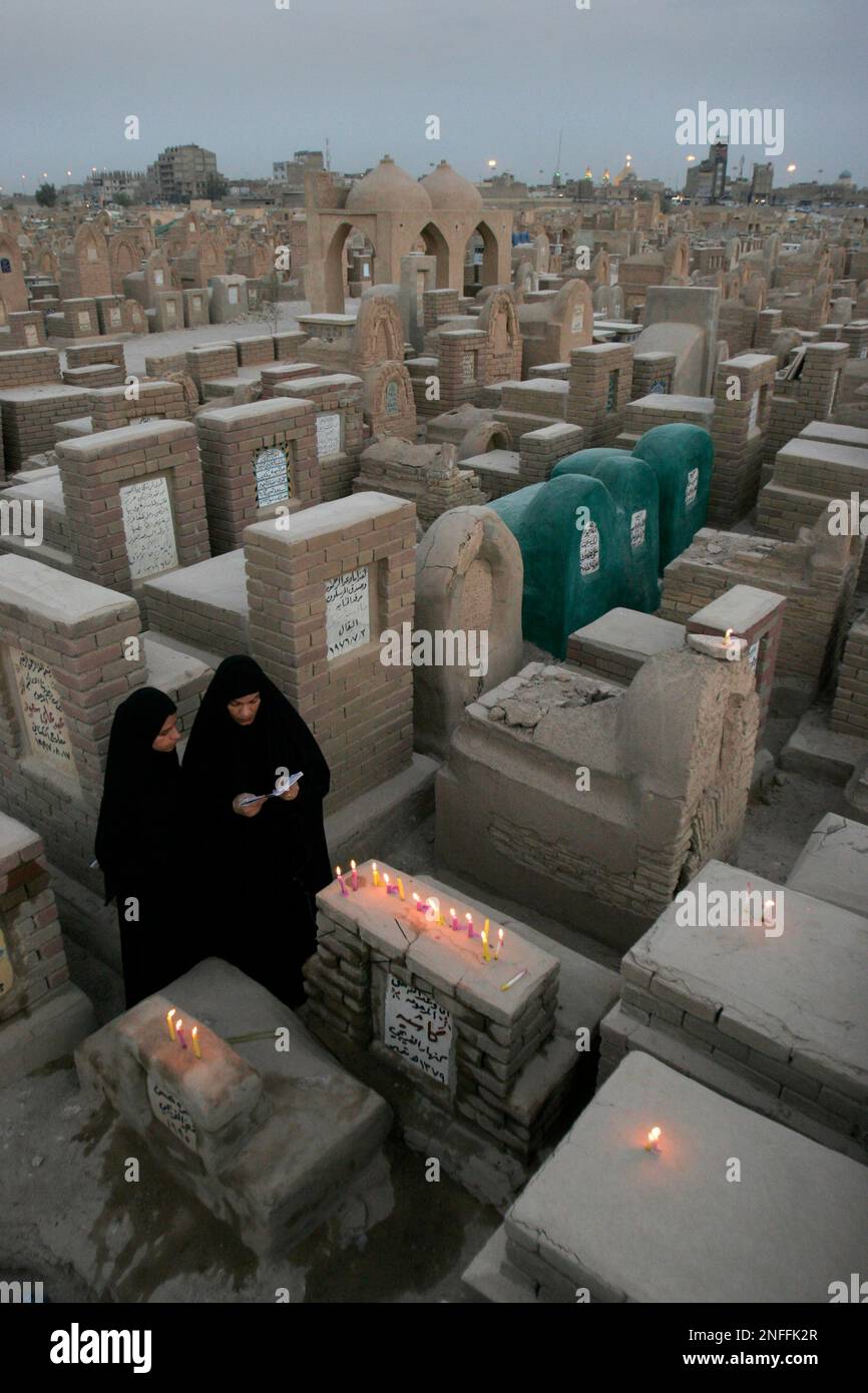 Relatives light candles and recite verses of the Holy Quran as they pay