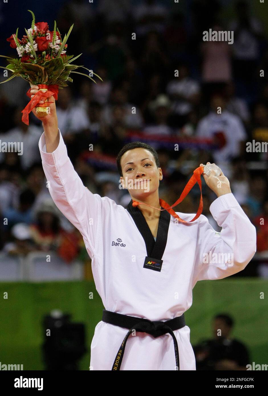 Silver medalist Canada's Karine Sergerie reacts on the podium during the medal ceremony for the women's taekwondo -67 kilogram class at the Beijing 2008 Olympics in Beijing, Friday, Aug. 22, 2008. (AP Photo/Matt Dunham) Stockfoto