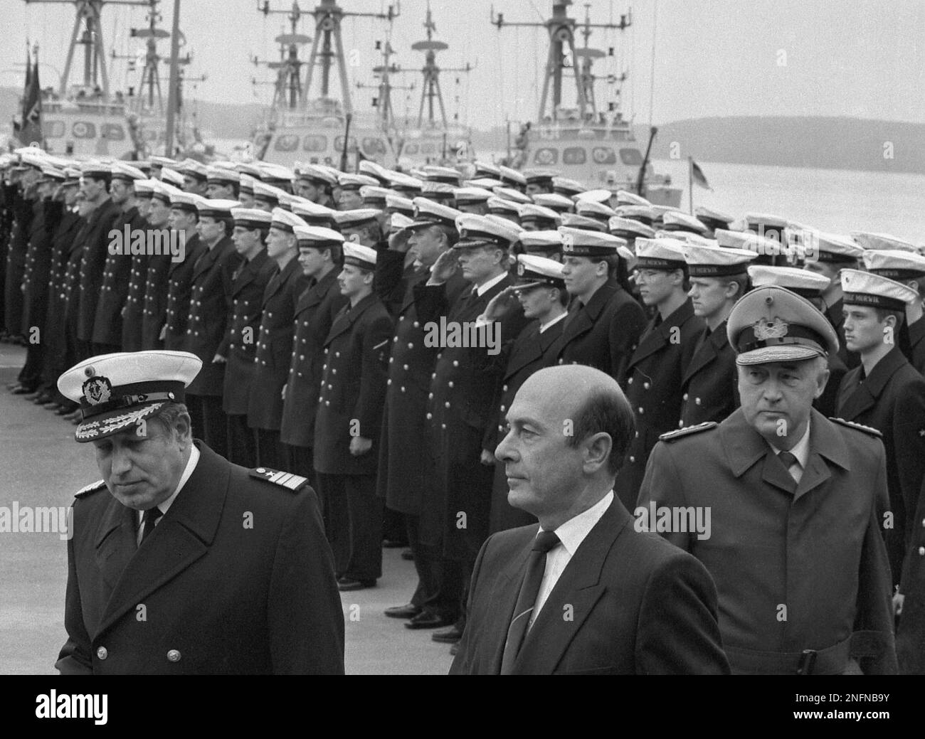 West German minister of defence, Manfred Woerner, is flanked by parting