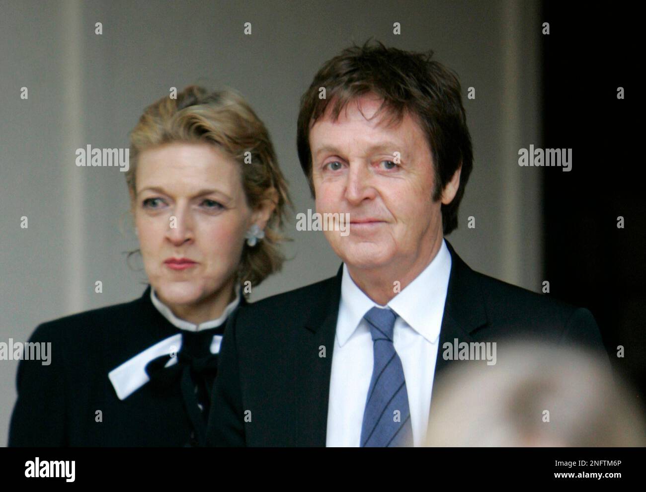 Sir Paul McCartney, right, leaves the central London's Royal Courts of