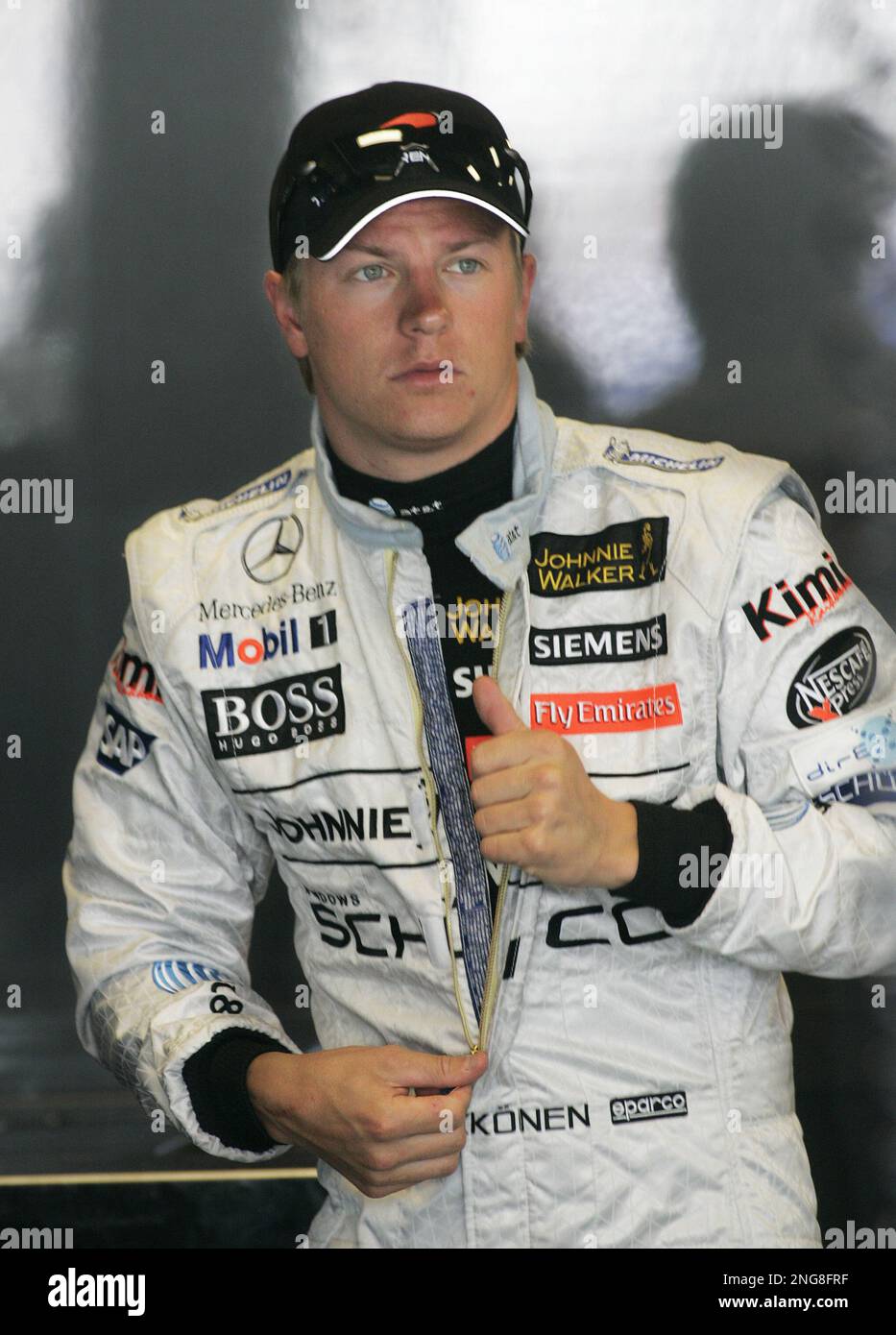 McLaren Mercedes Formula One driver Kimi Raikkonen of Finland unzips his  driving suit at practice for the United States Grand Prix at Indianapolis  Motor Speedway in Indianapolis, Friday, June 30, 2006. The