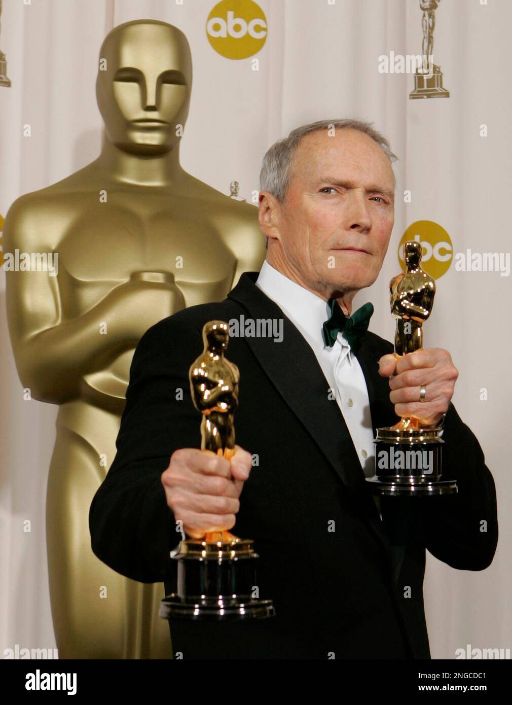 Director Clint Eastwood poses with the Oscars he won for best director