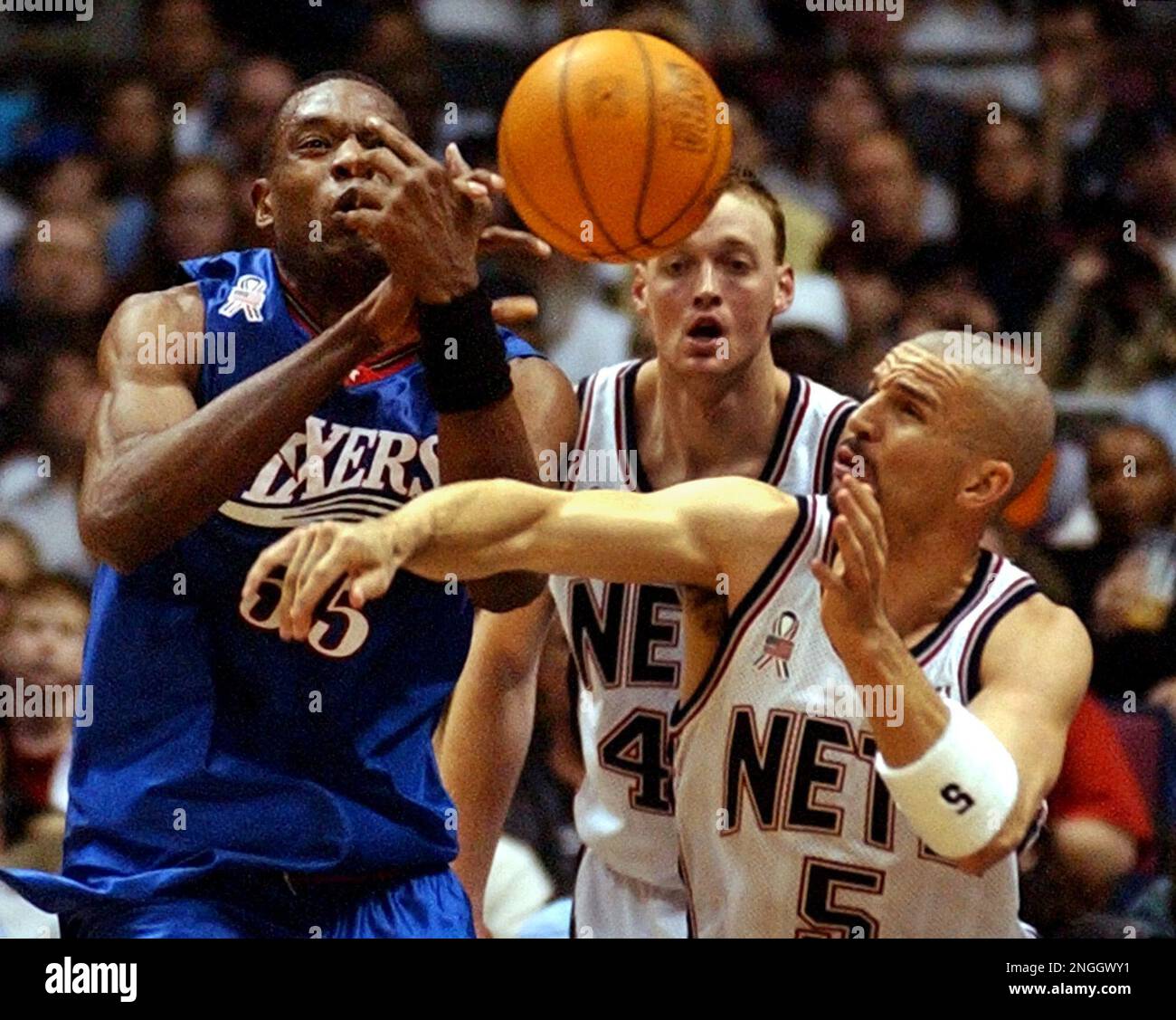 Forward Keith Van Horn of the New Jersey Nets goes to the basket as center  Dikembe Mutombo of the Philadelphia 76ers …