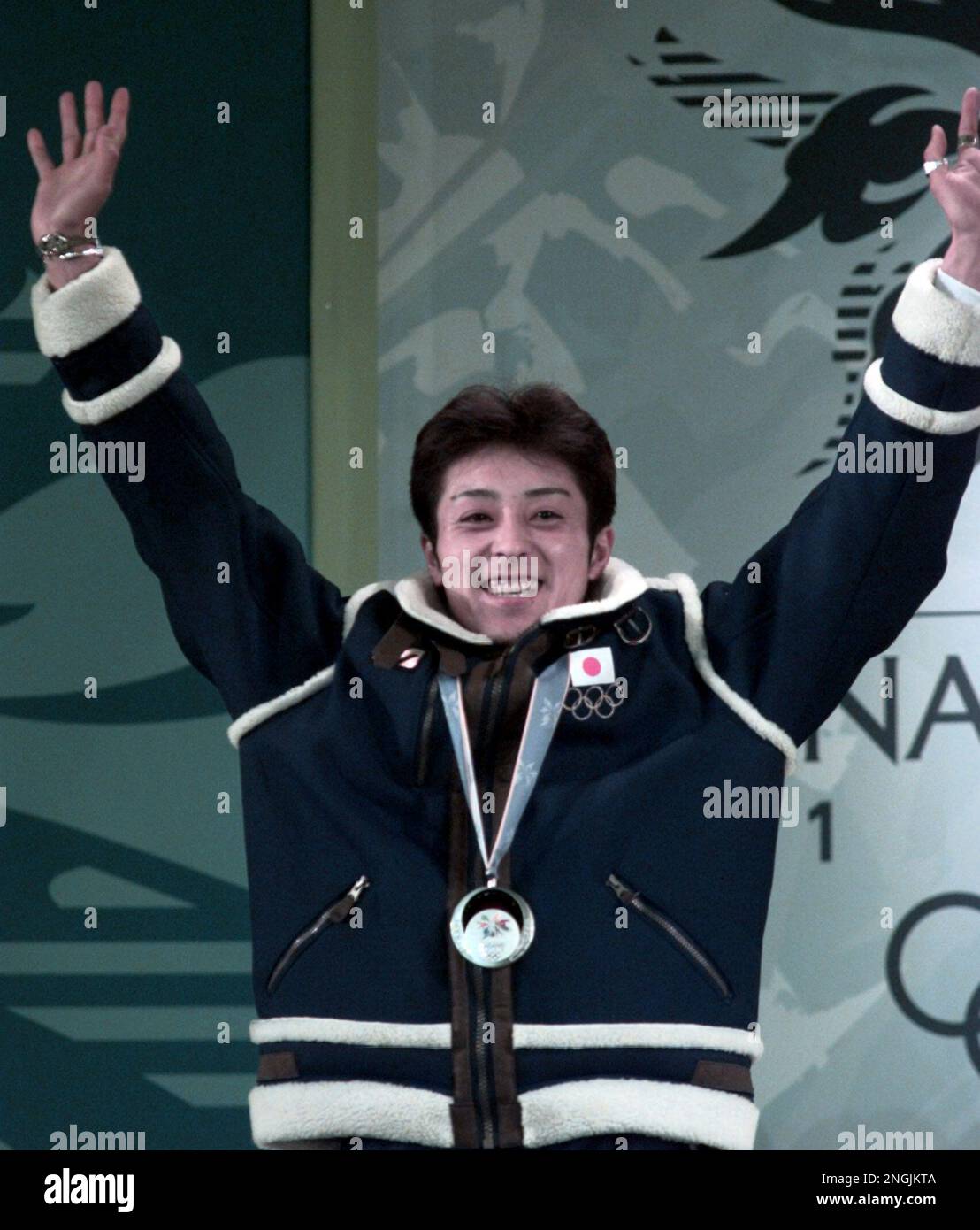 Japan's Kazuyoshi Funaki holds up his arms after he was awarded the