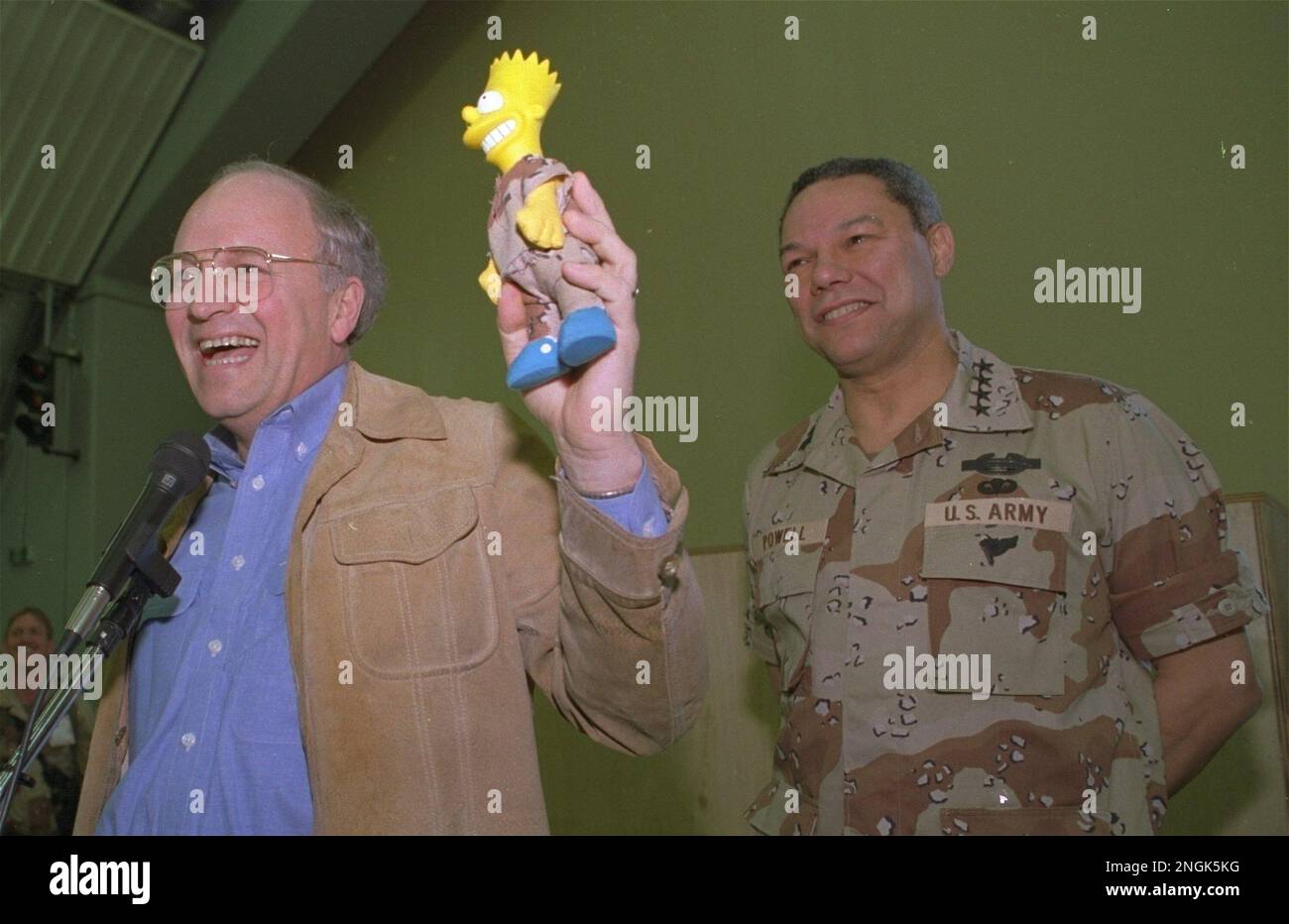 U.S. Defense Sec. Dick Cheney shows off a Bart Simpson doll dressed in ...