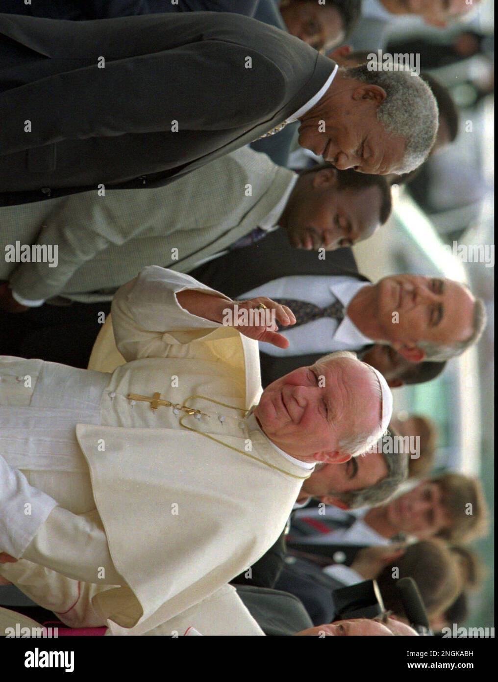 Pope John Paul II, right, waves as President Nelson Mandela, left