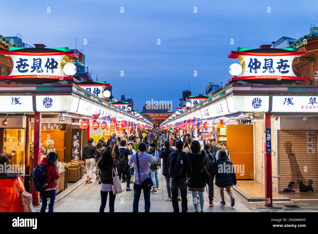 Tokio, Schrein und Sensoji-Tempel in Asakusa. Beginn der souvenir Nakamise Einkaufsstraße mit Tempel Tor am Ende der Straße voll mit Menschen. Abend. Stockfoto