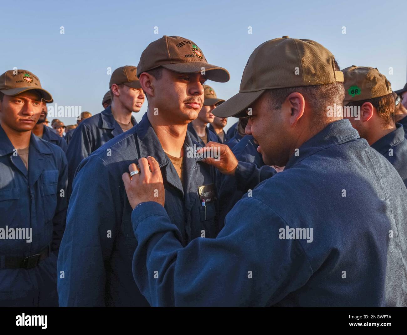 221127-N-RT917-1003 ARABISCHER GOLF (27. Nov. 2022) Ein Matrose stellt die Krähen eines Petty Officers während einer atemberaubenden Zeremonie an Bord der Guided-Missile Destroyer USS The Sullivans (DDG 68) am 27. Nov. im Arabischen Golf ein. Die Sullivans werden im US-Flottengebiet 5. eingesetzt, um die Sicherheit und Stabilität der Seeschifffahrt im Nahen Osten zu gewährleisten. Stockfoto