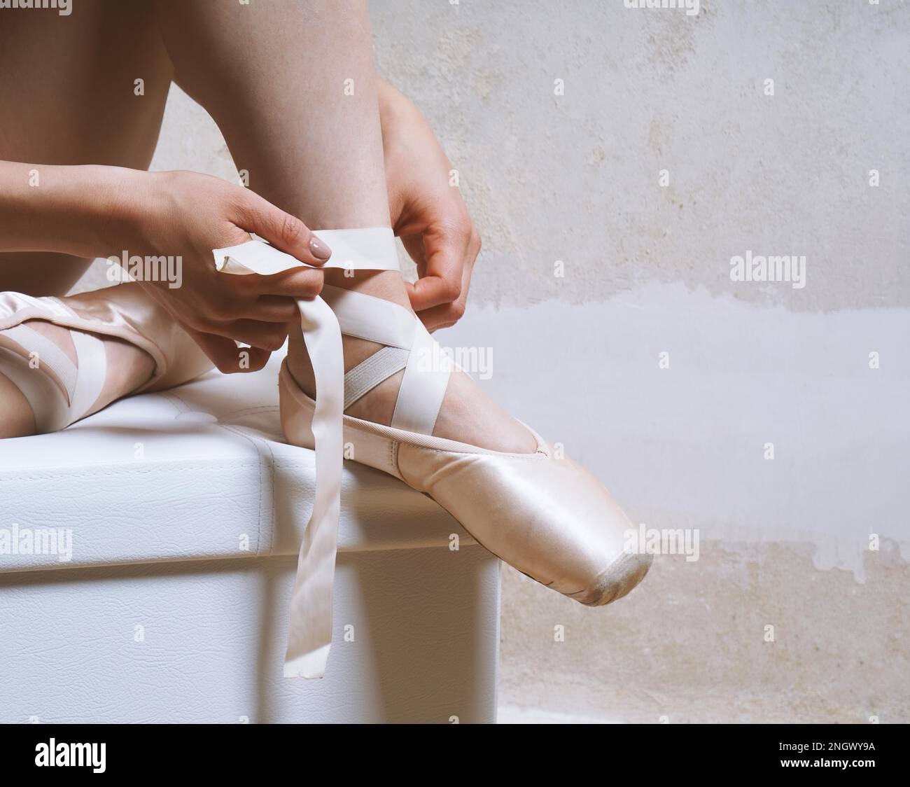 Beine der unkenntlich Ballerina ihre Pointe oder Ballett Schuhe binden Stockfoto