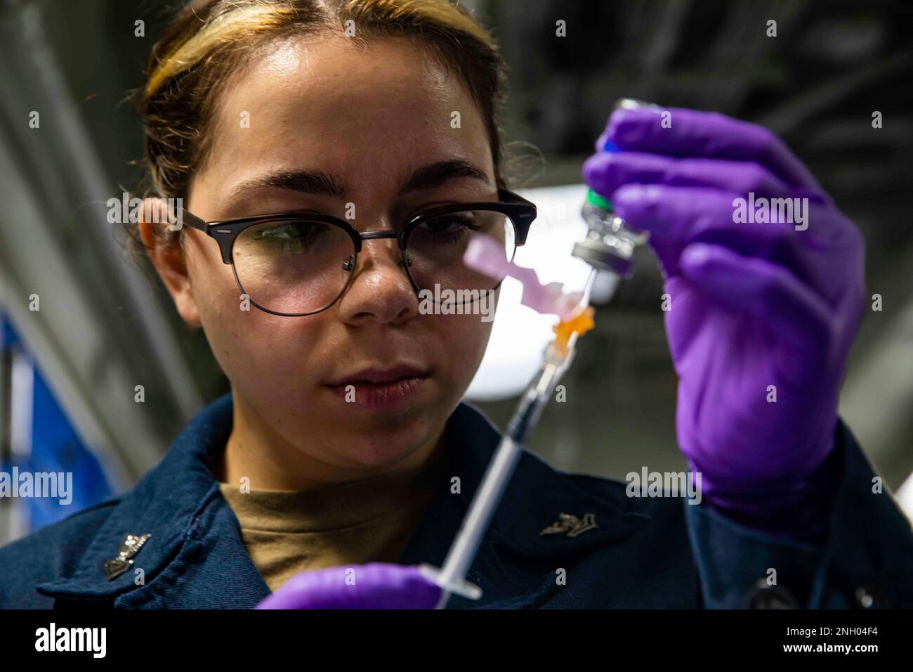 221202-N-XK047-2097 PAZIFIK (2. Dez. 2022) – Hospital Corpsman 2. Klasse Jewelia Mottor zieht eine Typhus-Impfung in eine Spritze an Bord des Amphibienschiffes USS Makin Island (LHD 8), 2. Dez. 2022. Typhus-Impfungen können Typhus verhindern, eine lebensbedrohliche Krankheit, die in vielen Regionen der Welt verbreitet ist und Symptome wie anhaltendes hohes Fieber, Schwäche, Bauchschmerzen und Appetitlosigkeit beinhaltet. Die Makin Island Amphibious Ready Group, bestehend aus dem Amphibienschiff USS Makin Island (LHD 8) und dem Amphibiendock USS Anchorage (LPD 23) und der USS John P. Stockfoto