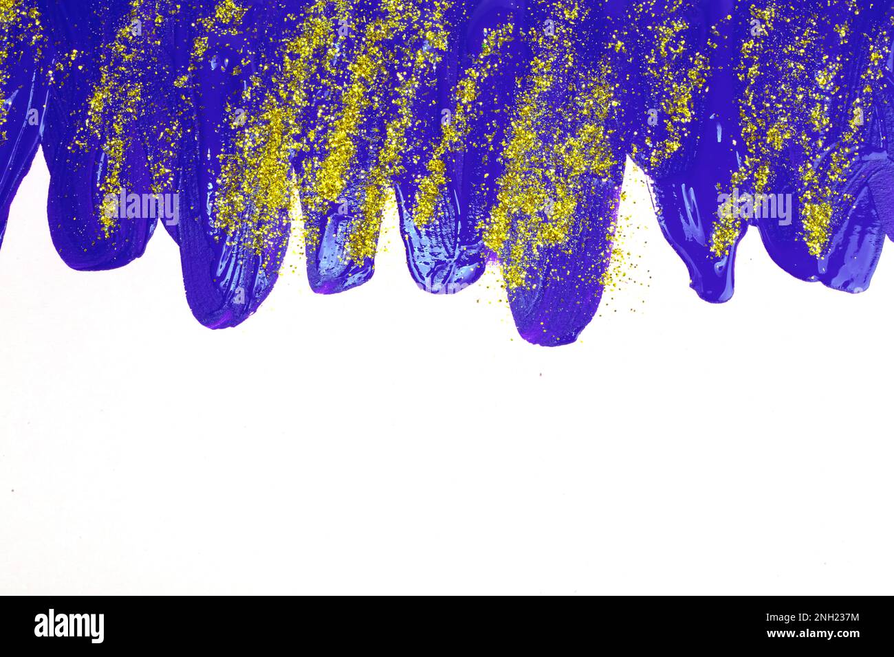 Auf weißem Hintergrund, blaue schillernde Flecken von fließender Acrylfarbe mit Goldglitzern. Stockfoto
