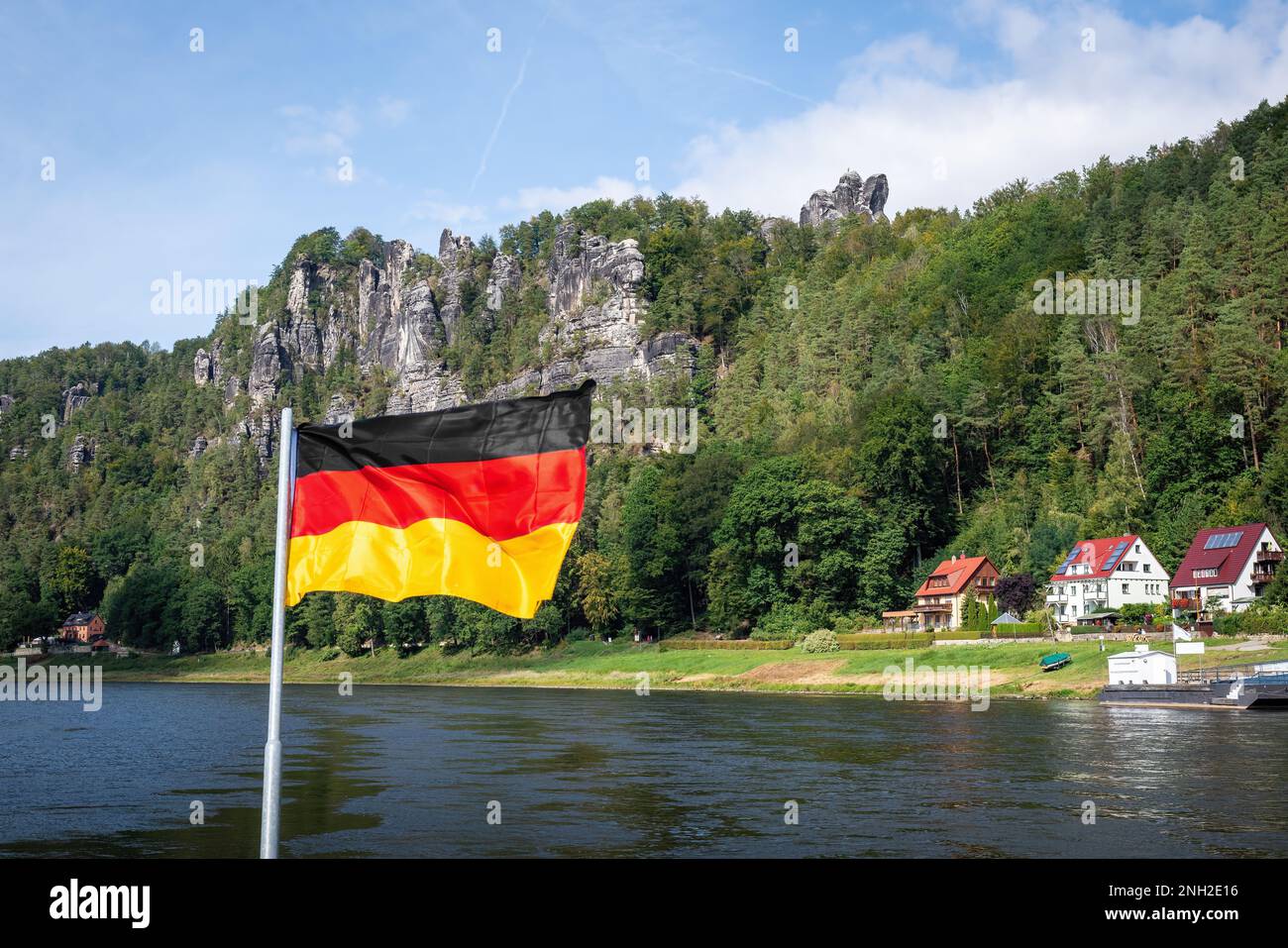 Deutsche Flagge vor dem Elbsandsteingebirge in Rathen bei der Bastei-Brücke (Basteibrücke) - Sachsen, Deutschland Stockfoto