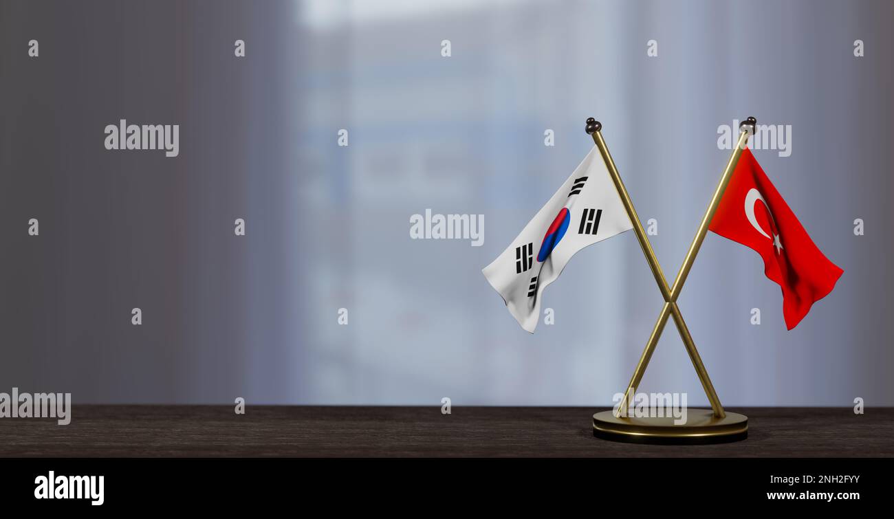 Südkorea und türkei-Flaggen auf dem Tisch. Verhandlungen zwischen Südkorea und Turkiye. Auf wenig unscharfem Hintergrund. 3D Arbeit und 3D Bild Stockfoto