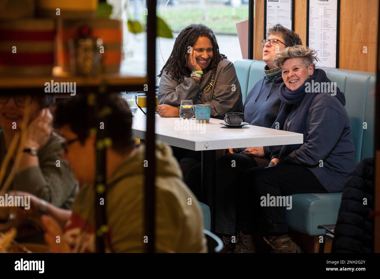 Eine Gruppe von Freundinnen in einem Café, die sich unterhalten. Manchester. Vereinigtes Königreich. Stockfoto