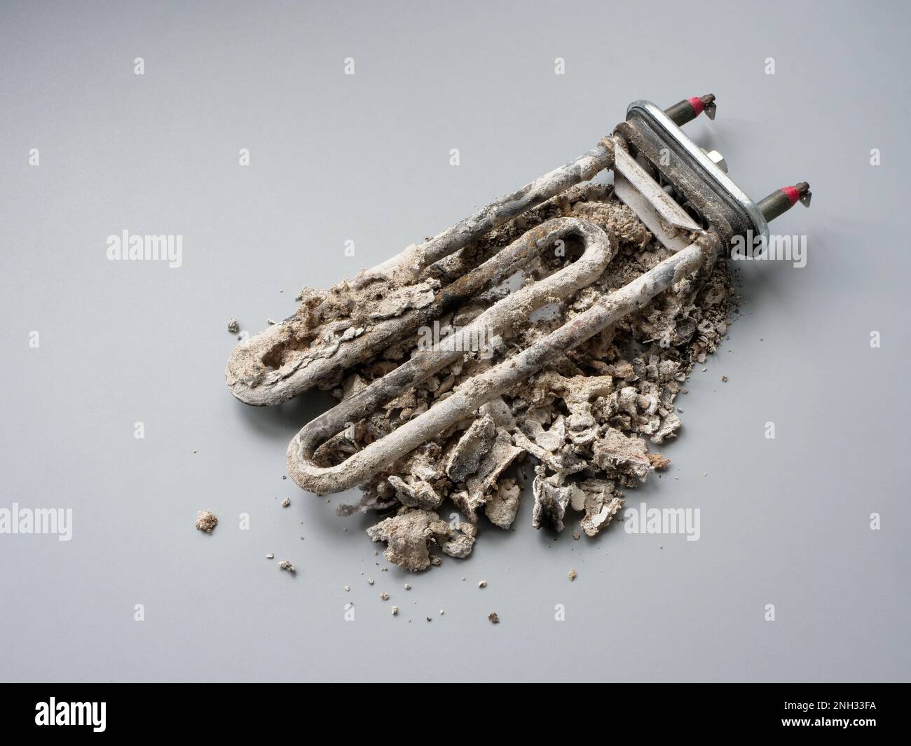 Durchgebranntes, gebrochenes Heizelement einer Waschmaschine oder eines Kessels. Stockfoto