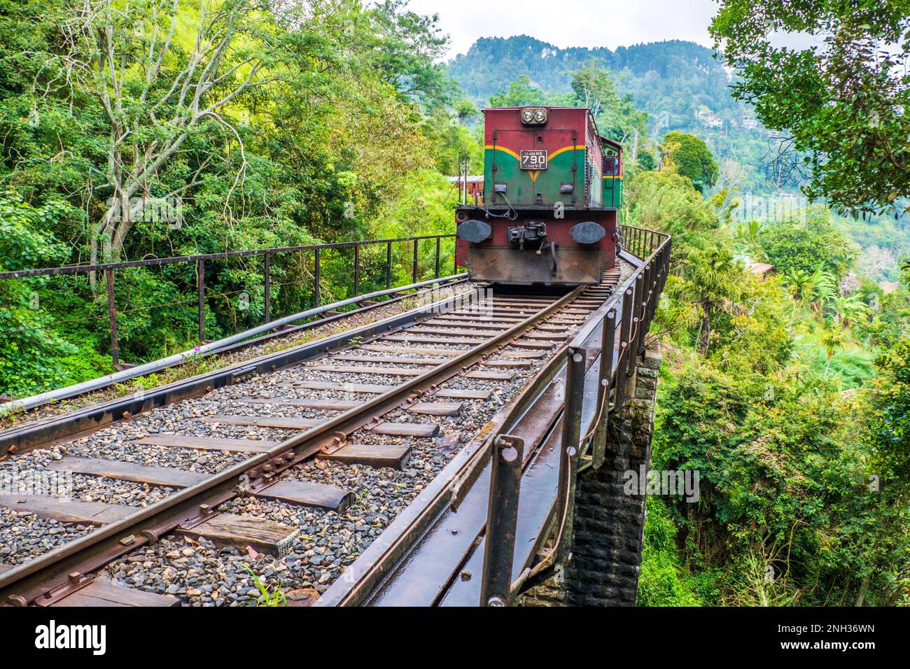 Sri Lanka, ein Zug, der eine Brücke auf der Kandy zur Ella-Eisenbahn überquert, die durch das Sri-lankische Hügelland führt Stockfoto