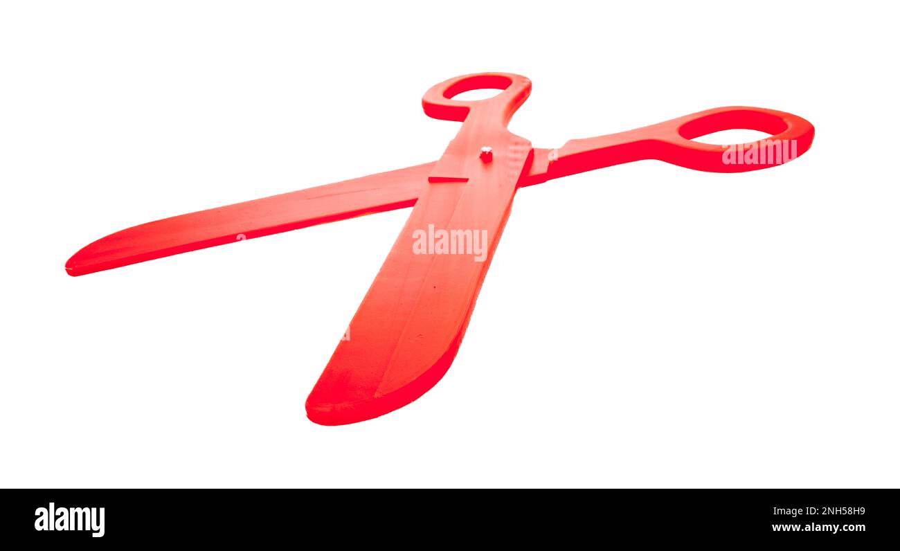 Eine rote Kunststoffschere in verformter Weitwinkelperspektive und Nahaufnahme, isoliert auf weiß oder transparent Stockfoto