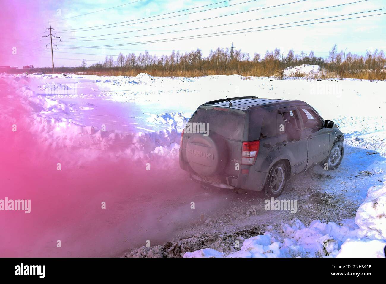 Off-Road-Auto „Suzuki Grand Vitara“ 4x4 aktiv und schnell in einem karmesinroten Rauch. Stockfoto