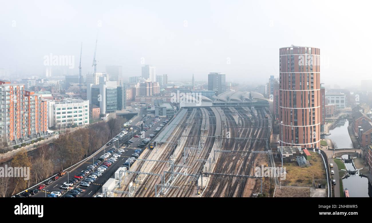 Ein Panoramablick auf die Skyline von Leeds mit Bahnhof und Schienen, die von Nebel und Nebel bedeckt sind und die Sicht für Zugfahrer beeinträchtigen Stockfoto