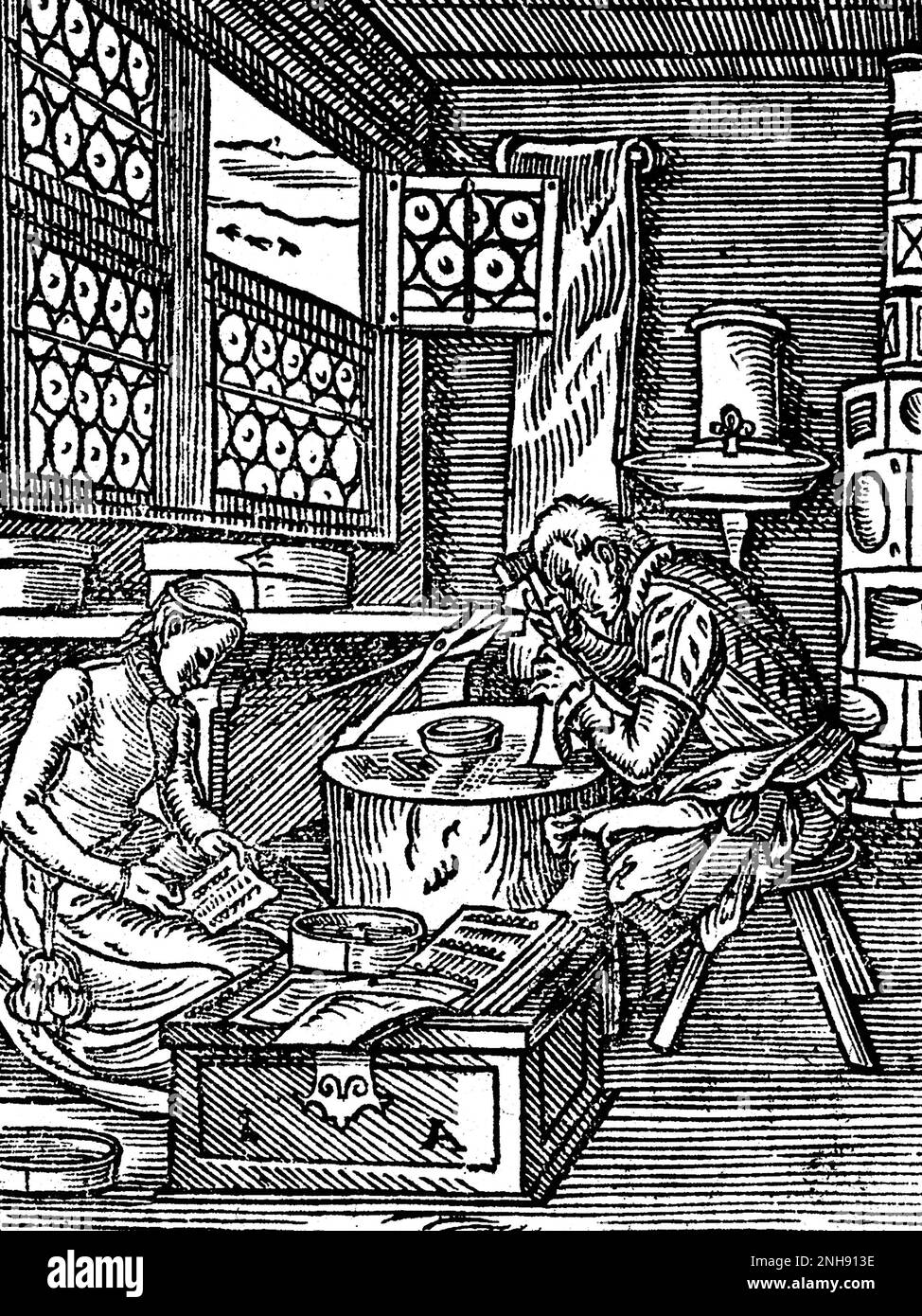 Ein Mann und eine Frau, die Nadeln herstellen. Woodcut aus Jost Ammans Handelsbuch, 1568. Stockfoto