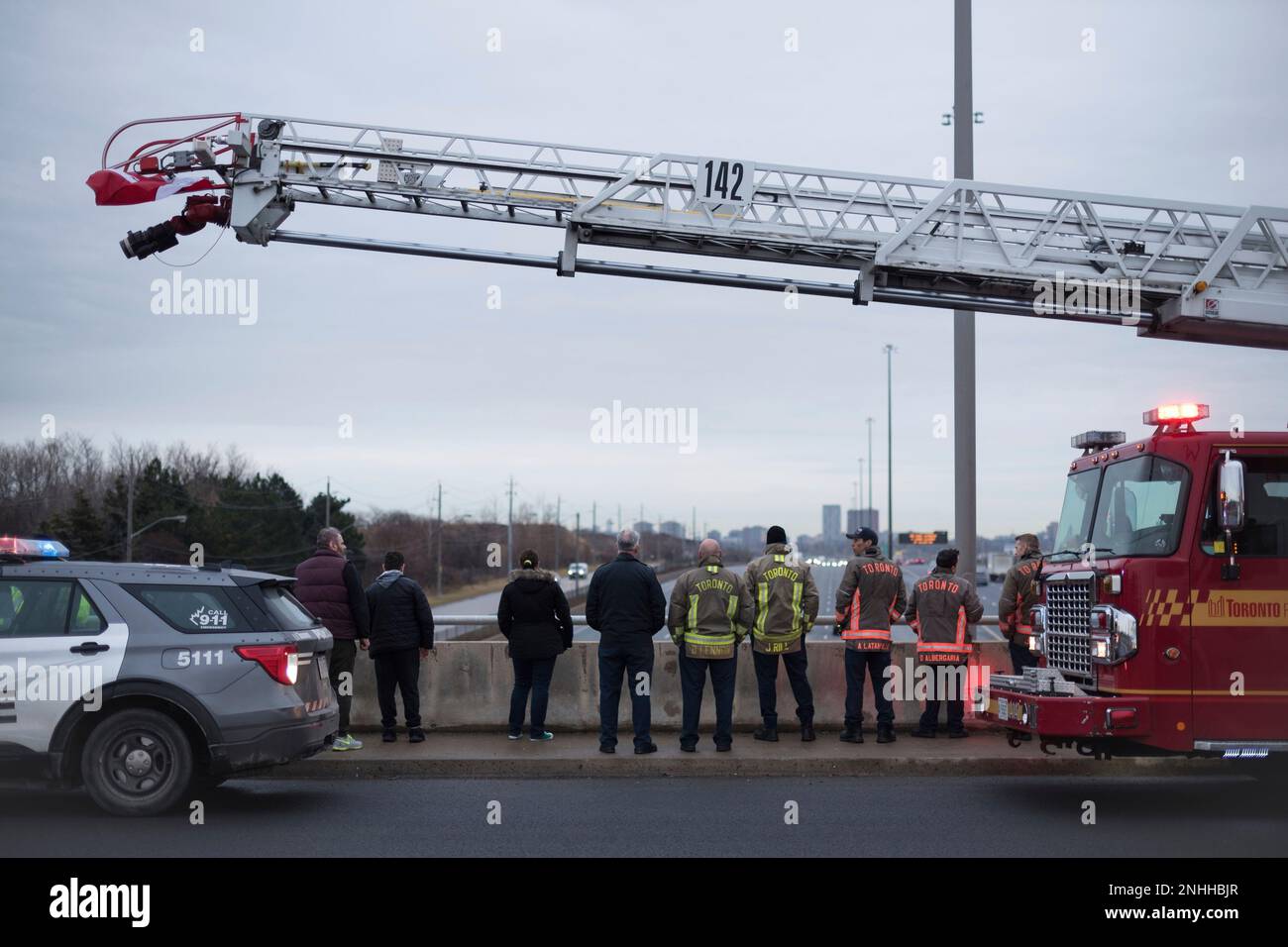 First responders wait on the Sheppard Avenue overpass to watch the procession for slain Ontario Provincial Const. Grzegorz Pierzchala, in Toronto, on Friday, Dec. 30, 2022. Police say Pierzchala responded to a vehicle in a ditch west of Hagersville, Ont., Tuesday afternoon and was fatally shot in an ambush when he arrived. (Tijana Martin /The Canadian Press via AP) Stockfoto