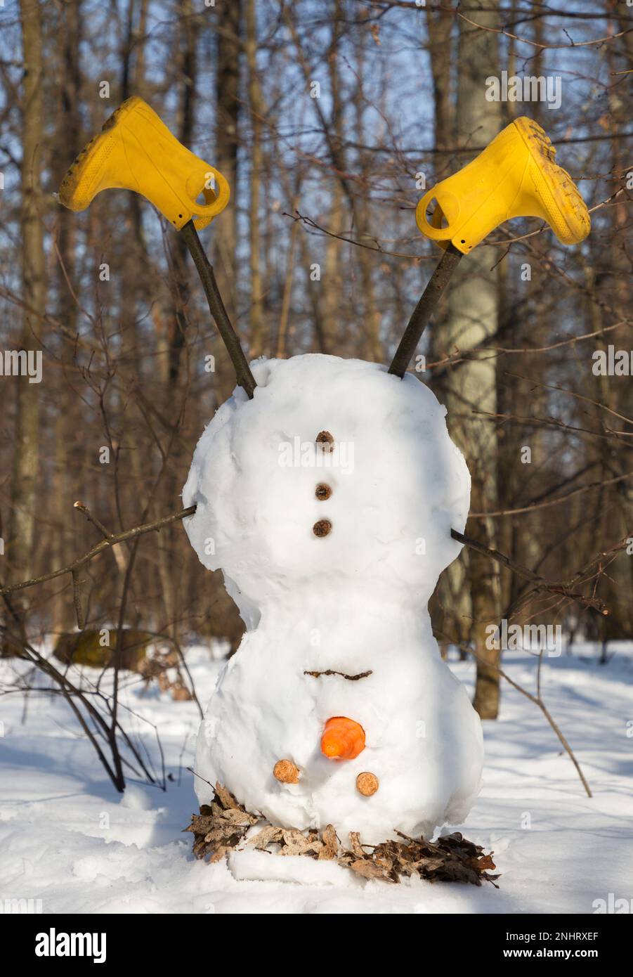 Der traurige Schneemann wurde auf den Kopf gestellt. Auf Wiedersehen Winterkonzept. Der Frühling kommt. Unerwarteter Märzschnee. Spaß sorglos Spaß. Mit Schnee spielen Stockfoto