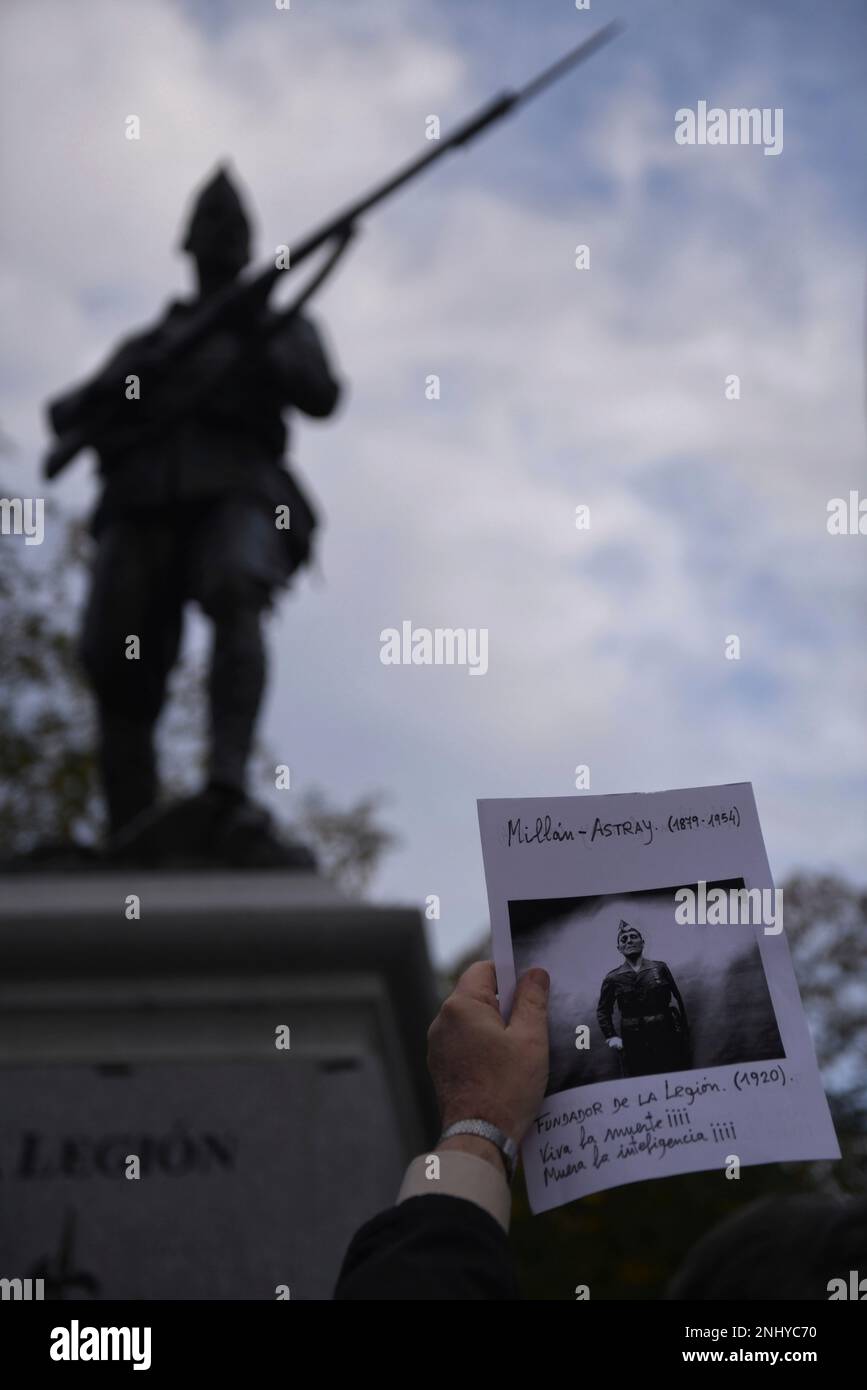 A man holds a poster with a photo of the founder of La Legion, Jose ...