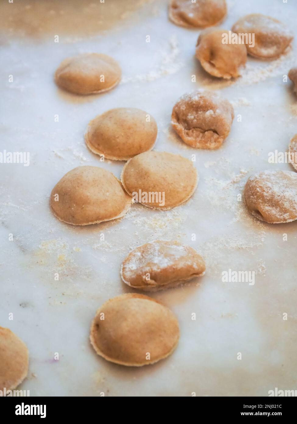 Nahaufnahme: Tortelli gefüllt mit Kürbis gefüllt mit hausgemachter Pasta, Oma kocht saisonale „Tortelli di zucca“, traditionelle italienische gefüllte Pas Stockfoto