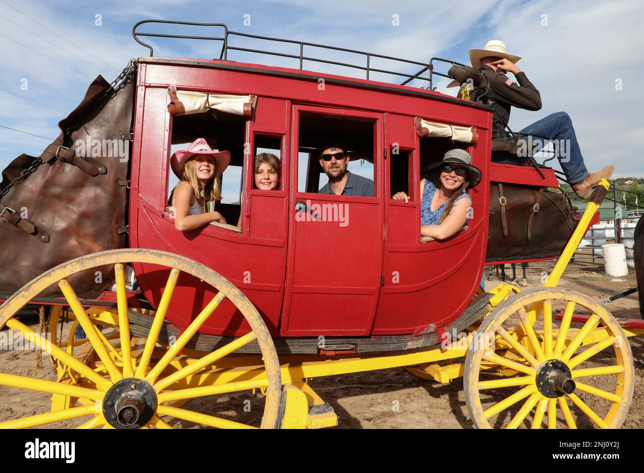 Die Familie Buirgy nimmt an der Abendshow Teil, wenn sie eine Fahrt in den Wagen des 4. Infanterie Division Fort Carson Mounted Color Guard Maultierteams zur Eröffnung der Garfield County Fair Rodeo Show, Rifle, Colorado, am 4. August 2022 machen. Die Garfield County Fair wird seit 84 Jahren zum Gedenken an das westliche und landwirtschaftliche Erbe veranstaltet. Stockfoto